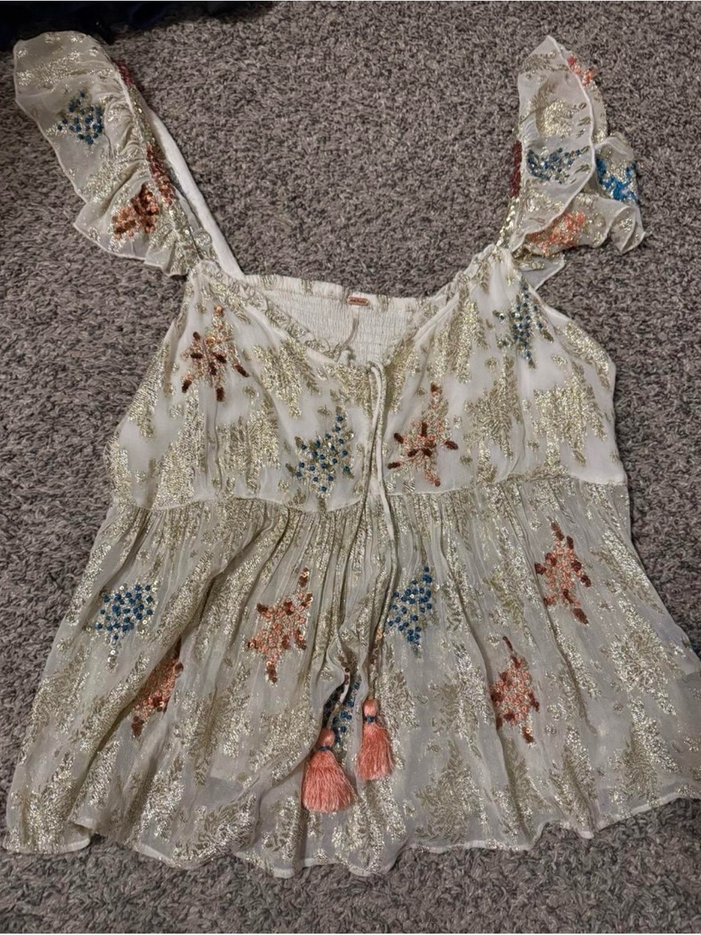 Free people top! It has one hole in both the armpits but other than that great